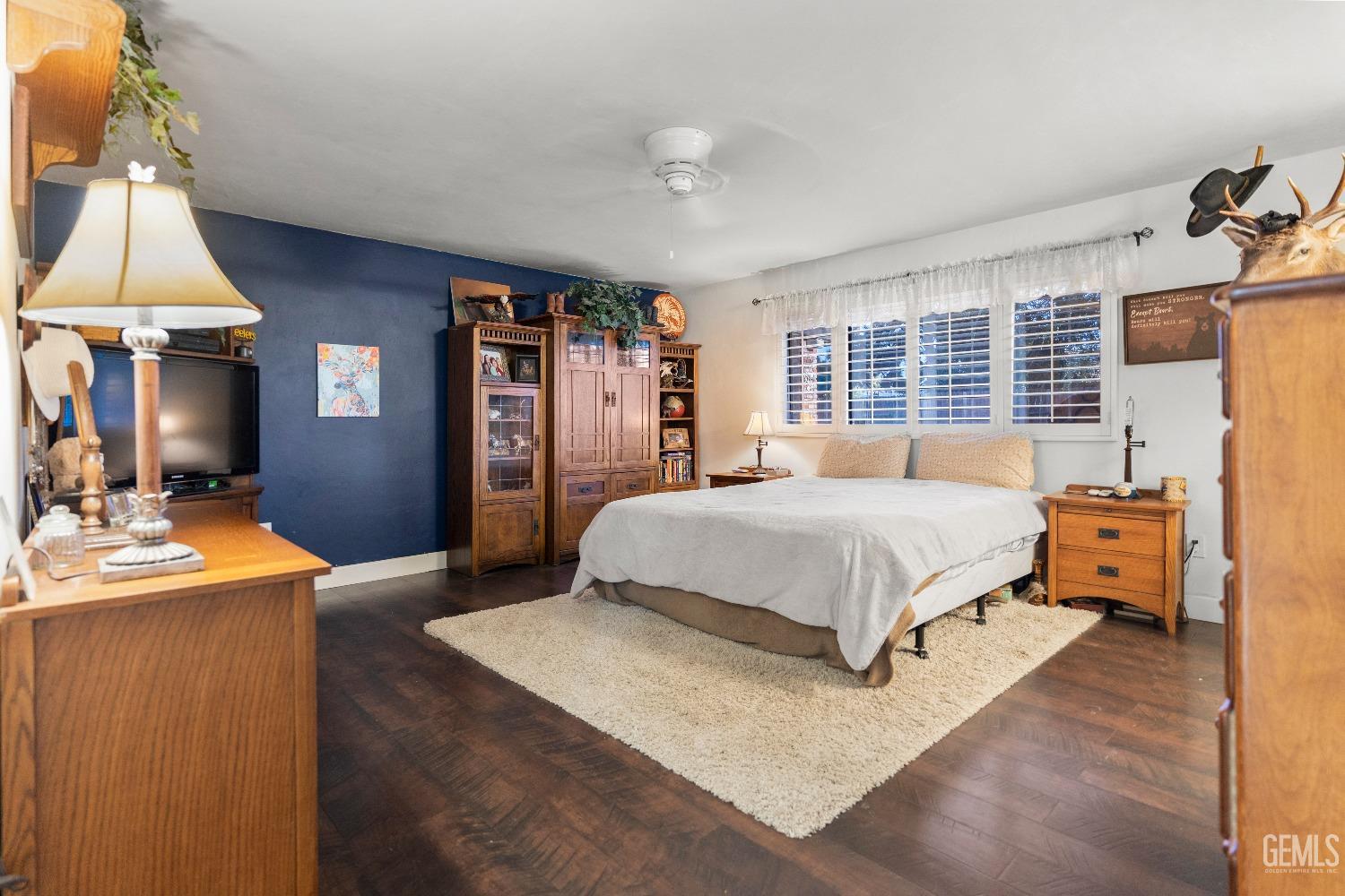 Undisclosed Address Bakersfield, CA 93309 - Photo 17 of 27 a spacious bedroom with a bed and a chandelier