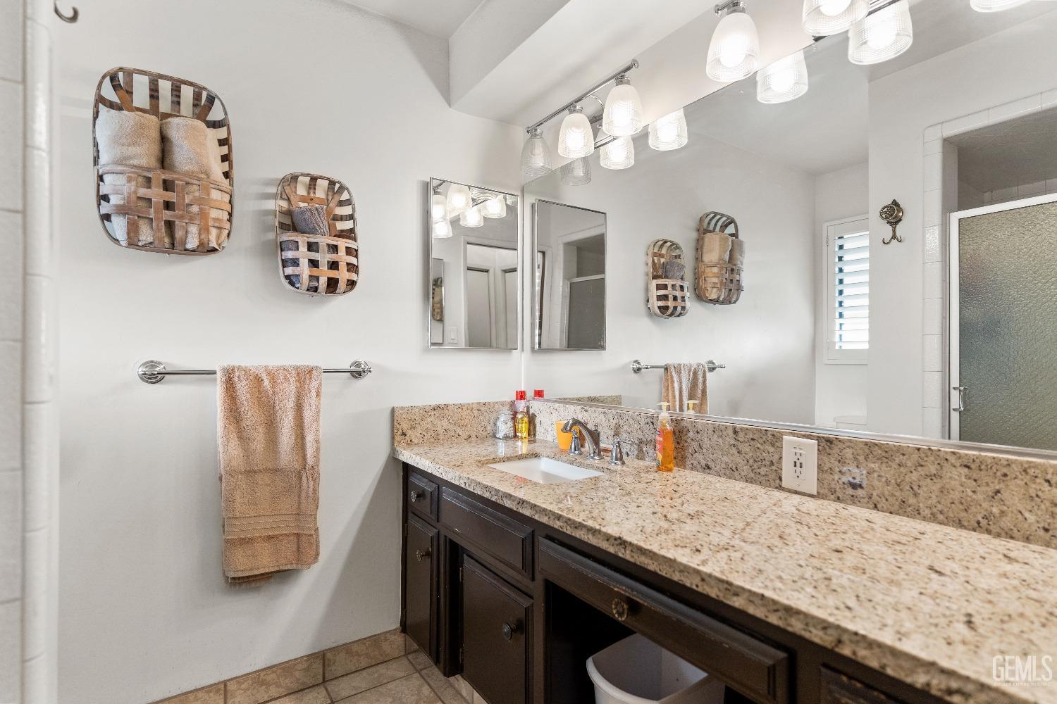 Undisclosed Address Bakersfield, CA 93309 - Photo 18 of 27 a bathroom with a sink double vanity and a mirror