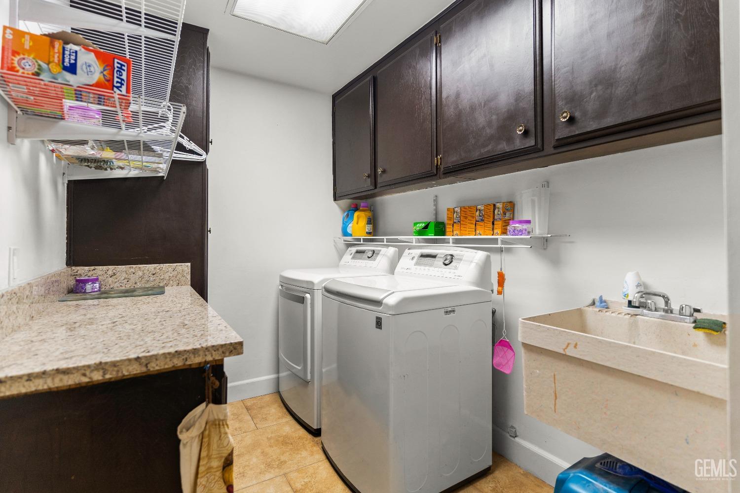 Undisclosed Address Bakersfield, CA 93309 - Photo 19 of 27 a utility room with cabinets washer and dryer