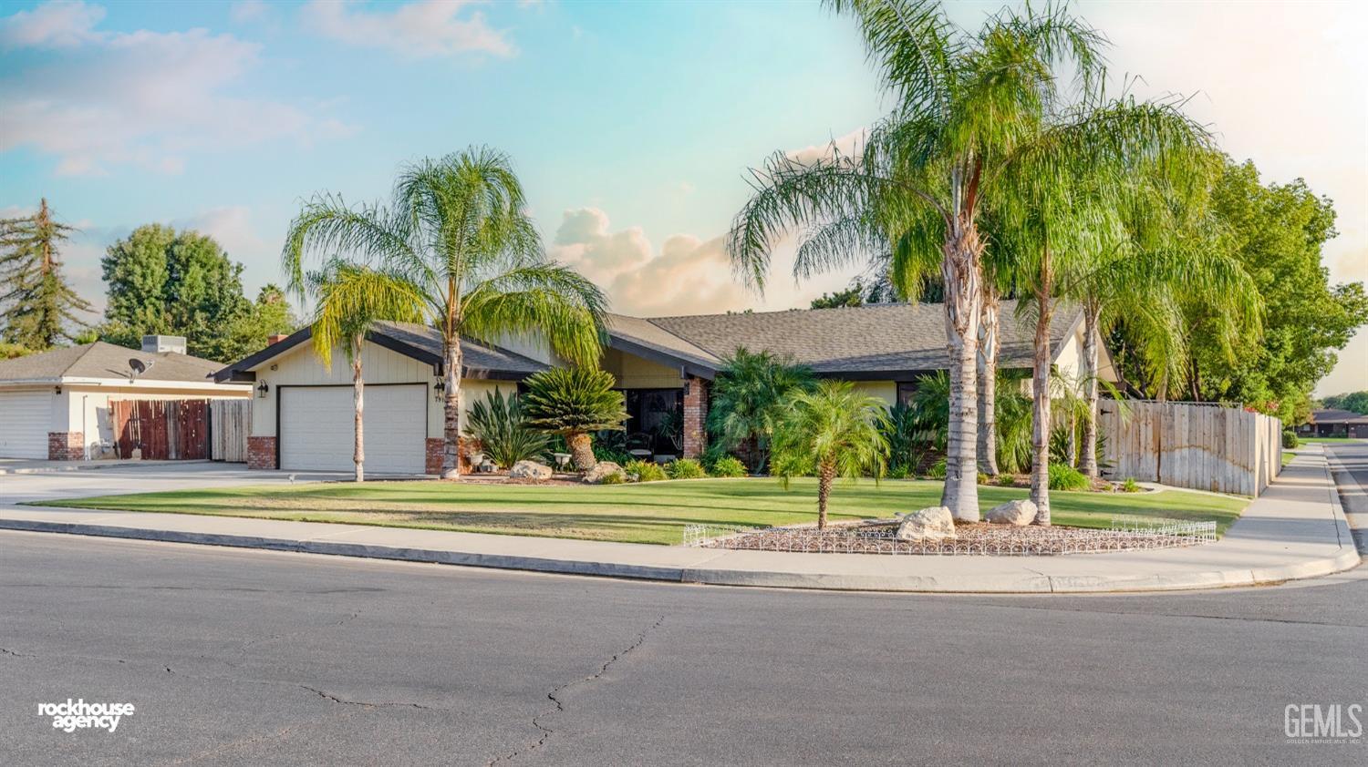 Undisclosed Address Bakersfield, CA 93309 - Photo 2 of 27 a view of a house with a yard and palm trees