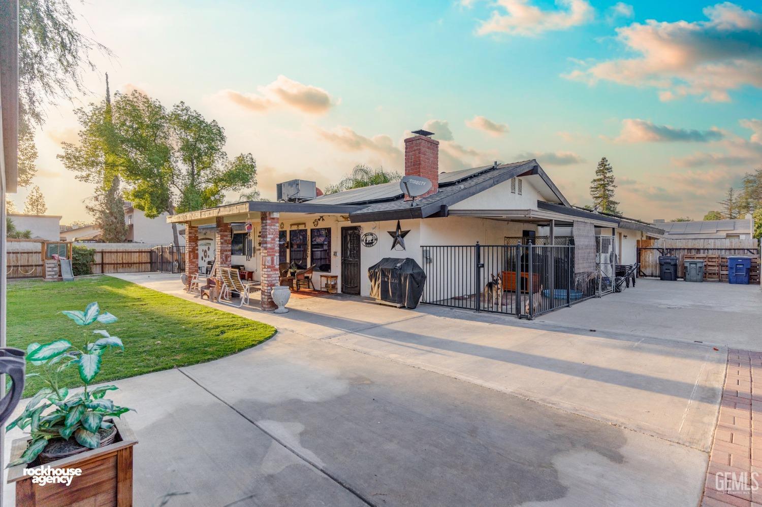 Undisclosed Address Bakersfield, CA 93309 - Photo 22 of 27 a front view of a house with garden
