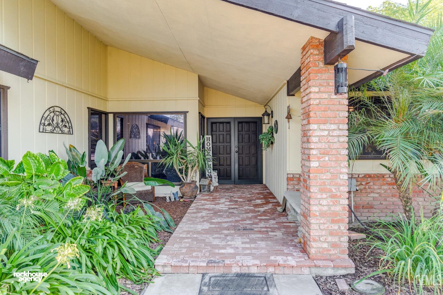 Undisclosed Address Bakersfield, CA 93309 - Photo 3 of 27 a front view of a house with garden