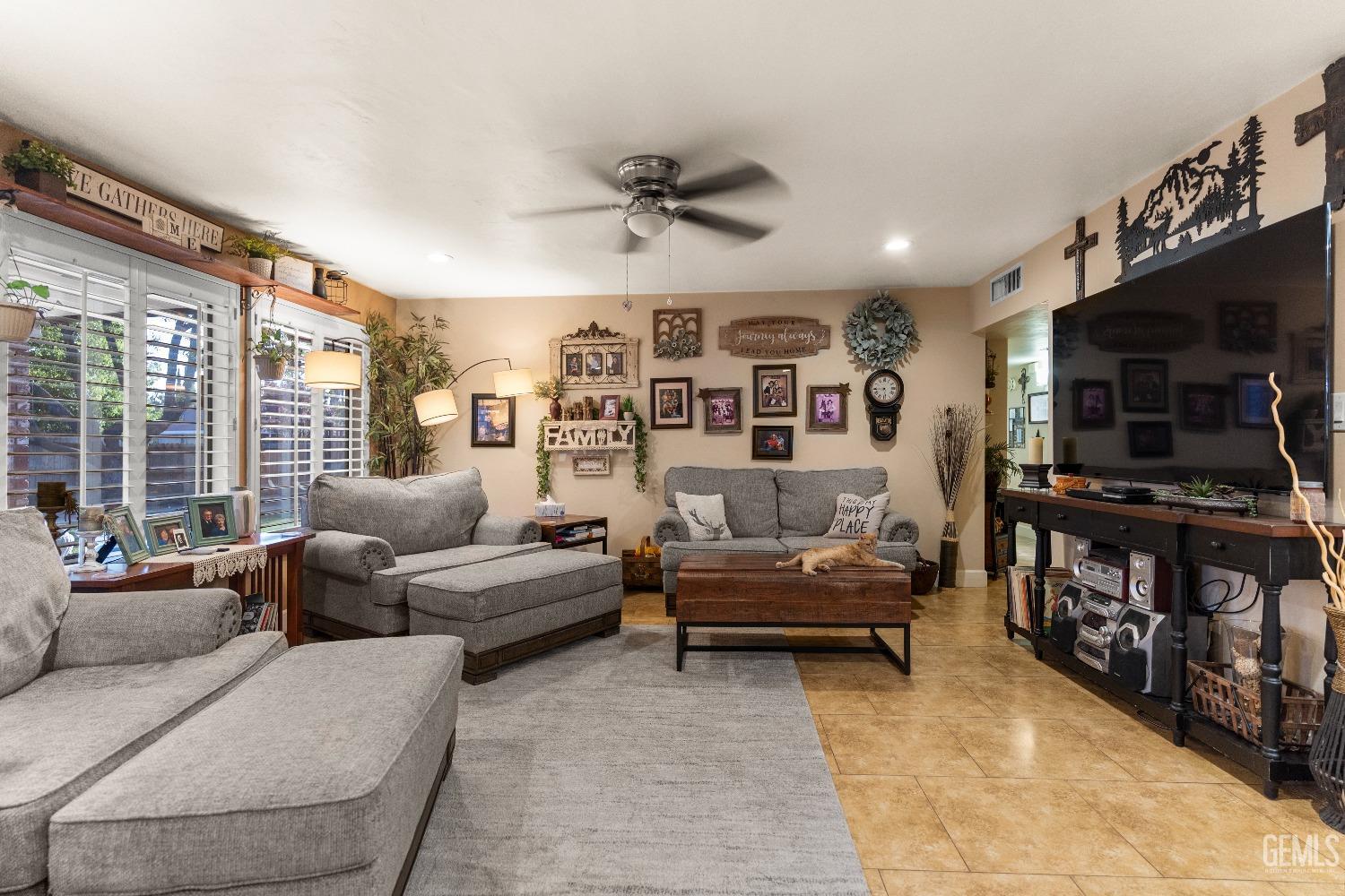 Undisclosed Address Bakersfield, CA 93309 - Photo 6 of 27 a living room with furniture and a flat screen tv