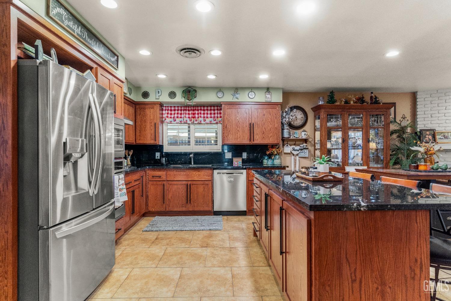 Undisclosed Address Bakersfield, CA 93309 - Photo 7 of 27 a kitchen with stainless steel appliances granite countertop a refrigerator and stove