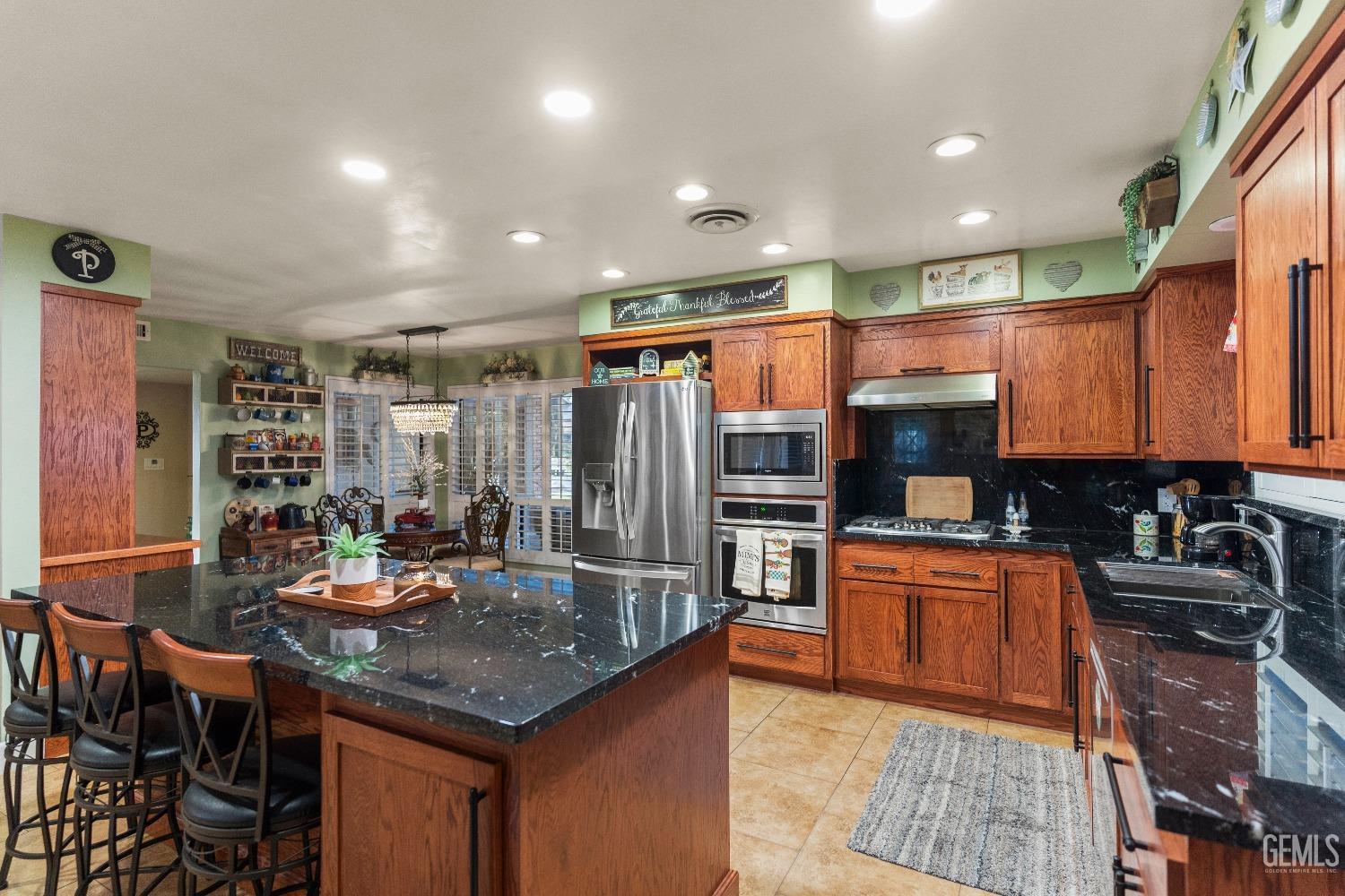 Undisclosed Address Bakersfield, CA 93309 - Photo 8 of 27 a kitchen with stainless steel appliances granite countertop a sink counter space cabinets and furniture