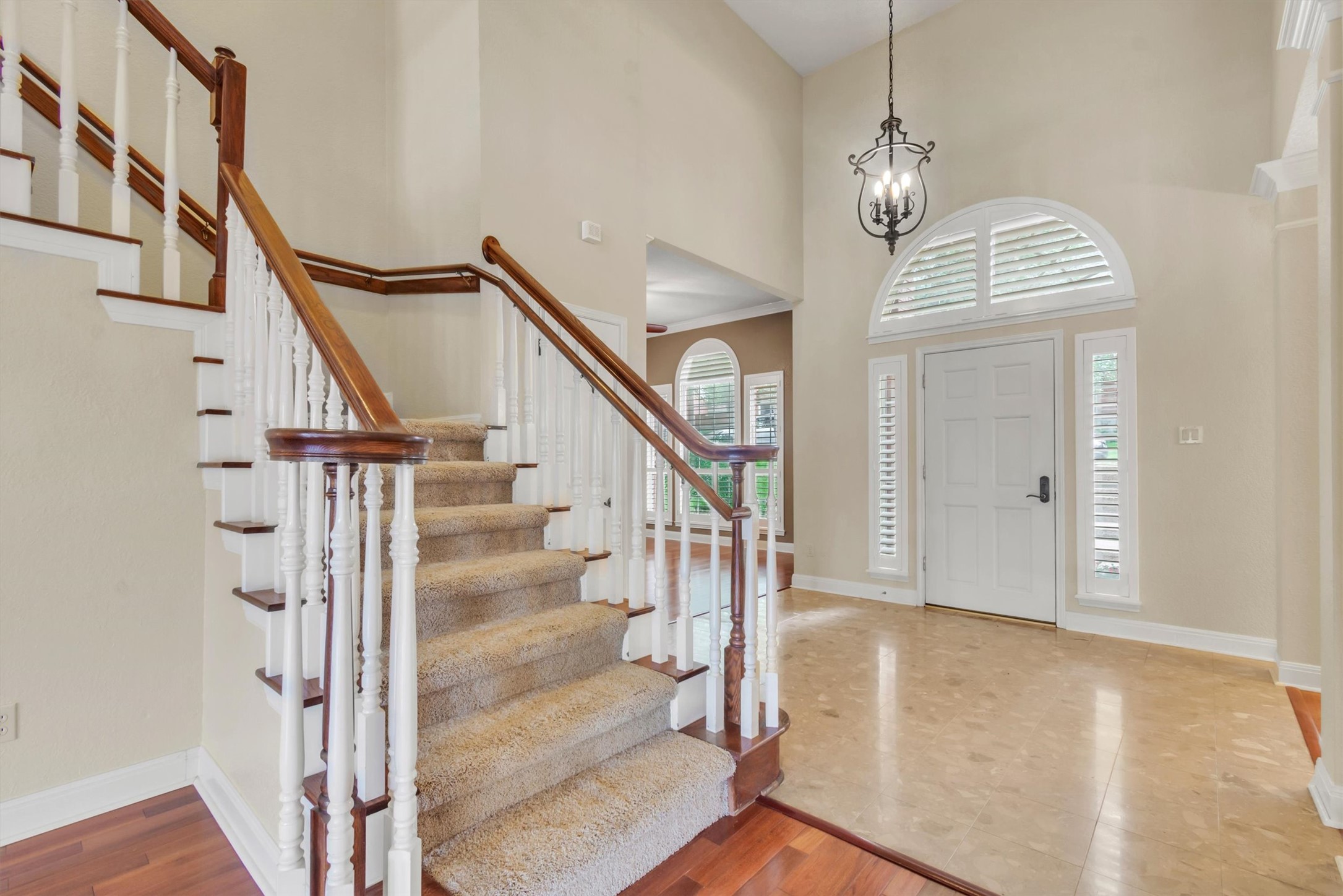 6008 Tributary Ridge Court Austin, TX 78759 - Photo 2 of 36 A grand staircase with carpeted treads and rich wood railing greets you in this elegant foyer.