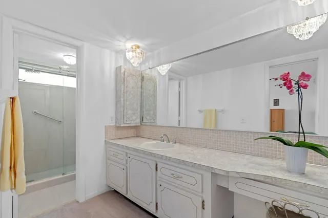 a bedroom with a bed a couch and a potted plant