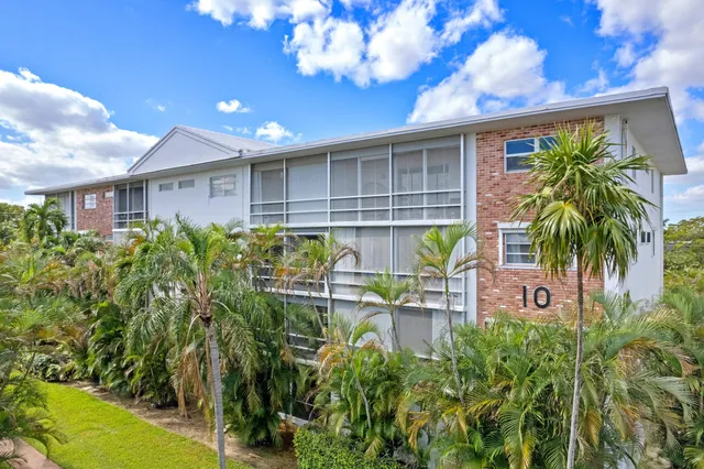 a front view of a house with sitting area