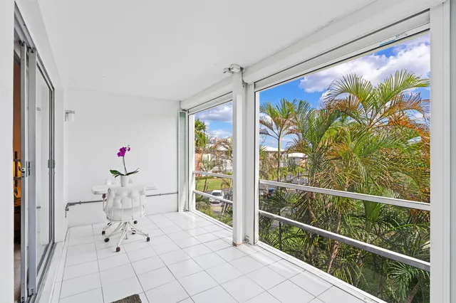 a view of a workspace with furniture and a potted plant