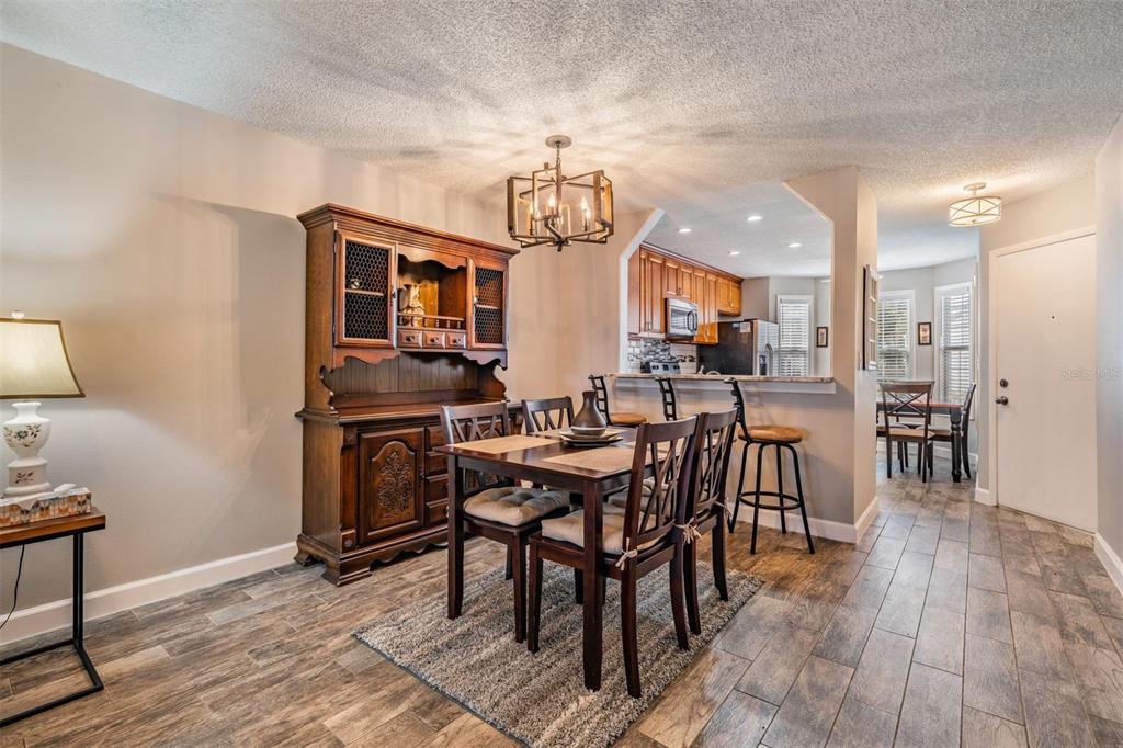 11308 Versailles Lane, Unit C Port Richey, FL 34668 - Photo 12 of 33 a view of a a dining room with furniture window and wooden floor