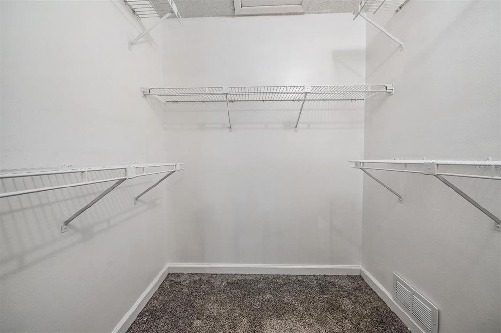 11308 Versailles Lane, Unit C Port Richey, FL 34668 - Photo 16 of 33 a view of a room with racks on the wall