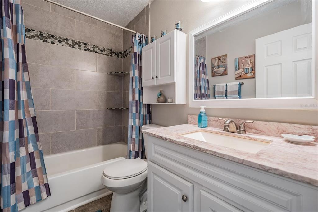11308 Versailles Lane, Unit C Port Richey, FL 34668 - Photo 21 of 33 a bathroom with a sink toilet and shower