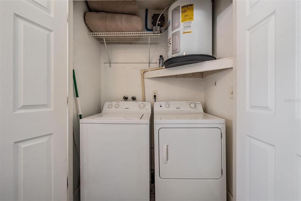 11308 Versailles Lane, Unit C Port Richey, FL 34668 - Photo 24 of 33 a utility room with dryer and washer