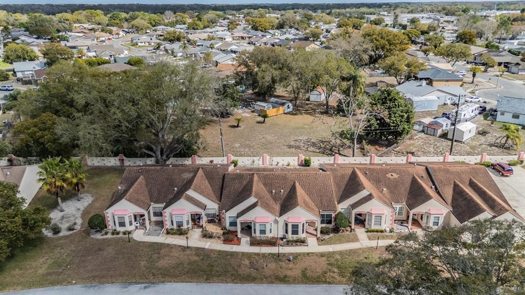 11308 Versailles Lane, Unit C Port Richey, FL 34668 - Photo 28 of 33 an aerial view of residential houses and outdoor space