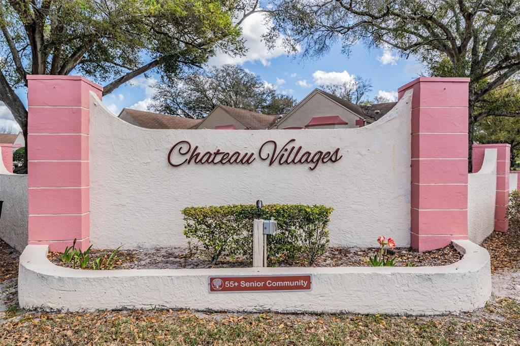 11308 Versailles Lane, Unit C Port Richey, FL 34668 - Photo 29 of 33 a street sign on a wall next to a building