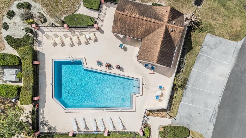 11308 Versailles Lane, Unit C Port Richey, FL 34668 - Photo 30 of 33 an aerial view of a house with a swimming pool