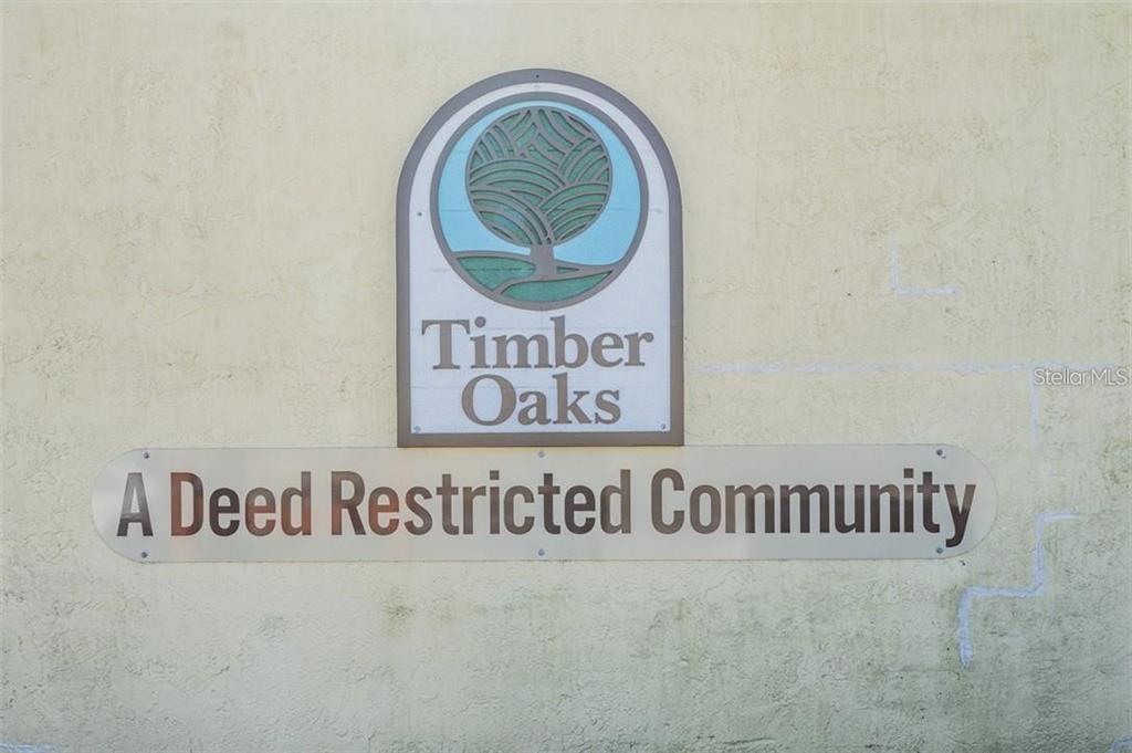 11308 Versailles Lane, Unit C Port Richey, FL 34668 - Photo 32 of 33 a view of a sign in a kitchen