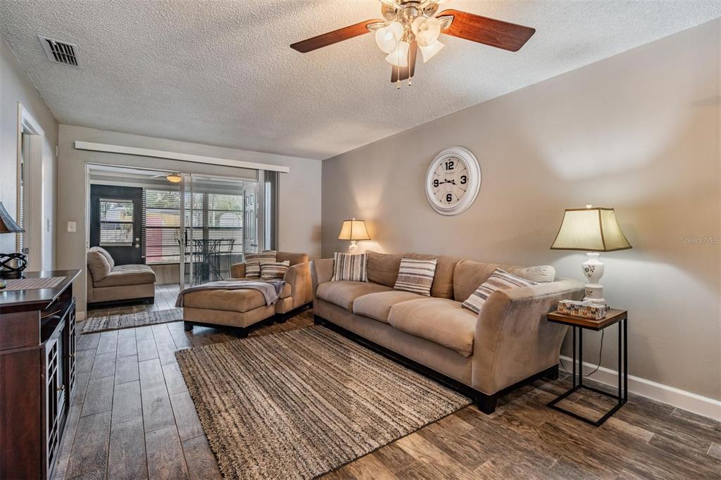 11308 Versailles Lane, Unit C Port Richey, FL 34668 - Photo 9 of 33 a living room with furniture and a large window