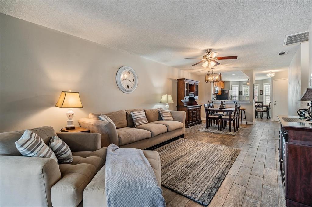 11308 Versailles Lane, Unit C Port Richey, FL 34668 - Photo 10 of 33 a living room with furniture and wooden floor