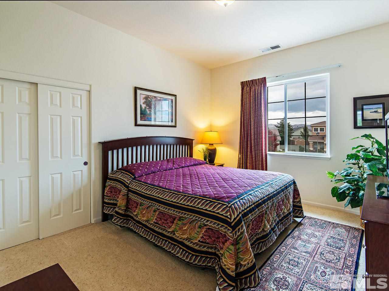1635 Crater Court Reno, NV 89521 - Photo 16 of 25 a bed sitting in a bedroom next to a window