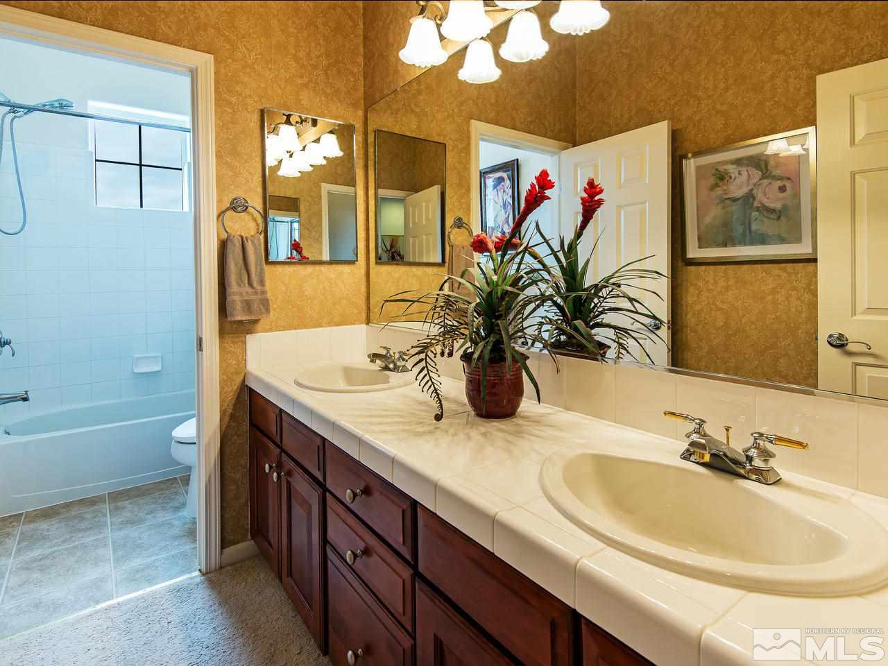 1635 Crater Court Reno, NV 89521 - Photo 17 of 25 a bathroom with a granite countertop sink and a mirror