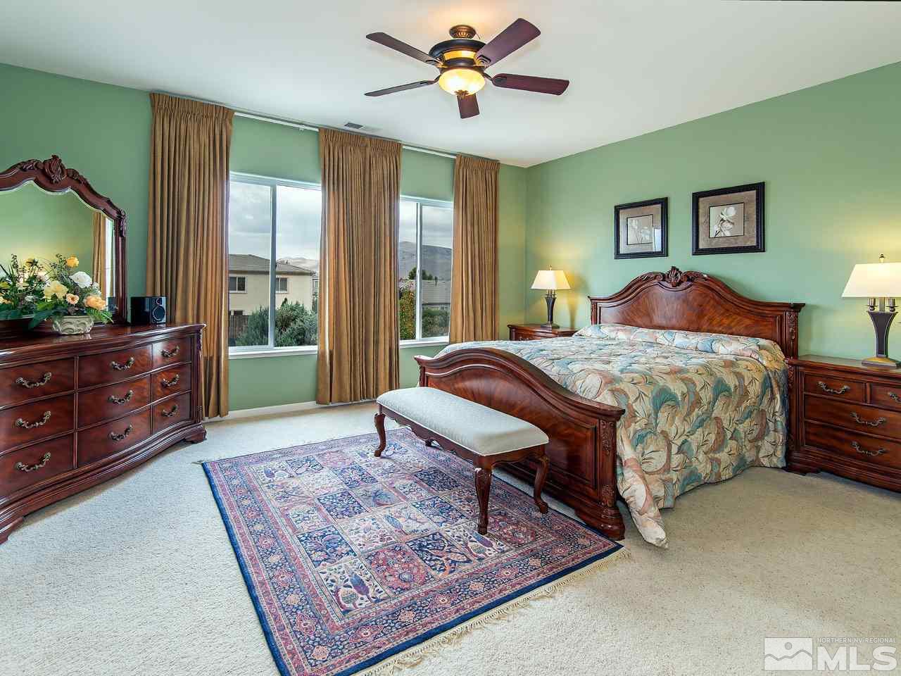 1635 Crater Court Reno, NV 89521 - Photo 19 of 25 a bedroom with a bed a dresser next to a window