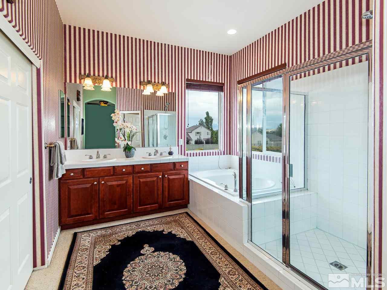 1635 Crater Court Reno, NV 89521 - Photo 20 of 25 a bathroom with a tub sink and mirror