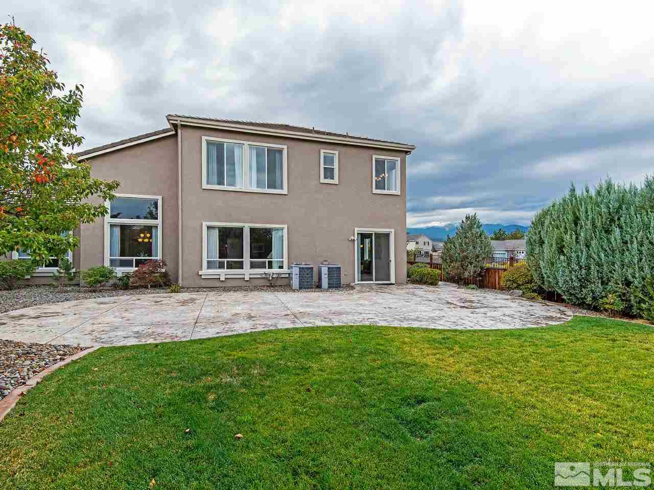1635 Crater Court Reno, NV 89521 - Photo 21 of 25 a backyard of a house with table and chairs plants and large trees