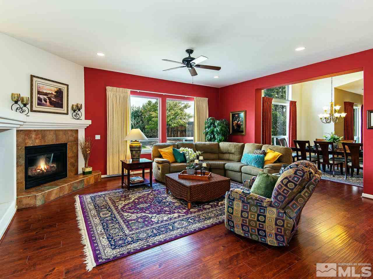 1635 Crater Court Reno, NV 89521 - Photo 5 of 25 a living room with furniture a fireplace and a large window