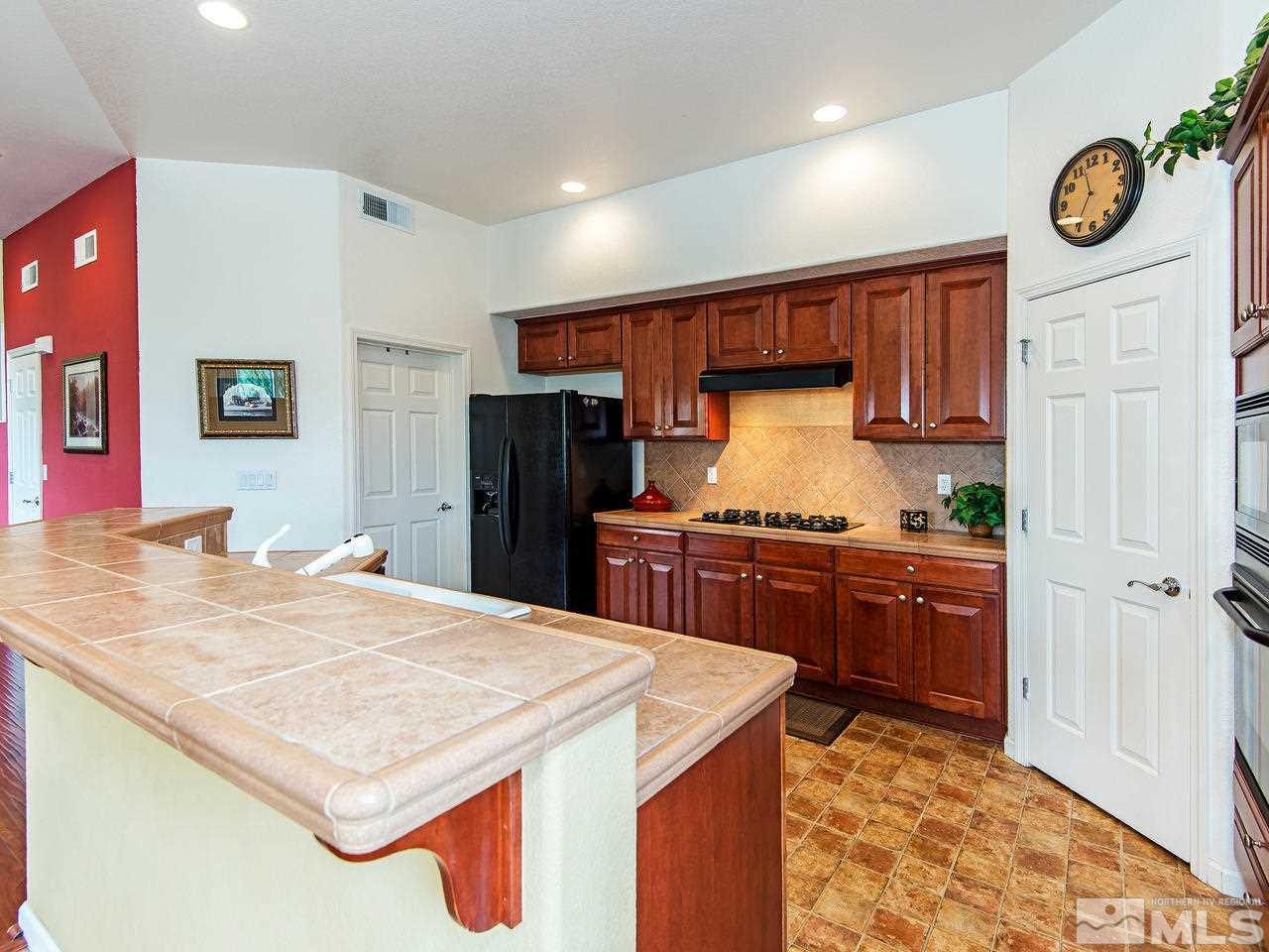 1635 Crater Court Reno, NV 89521 - Photo 10 of 25 a kitchen with granite countertop cabinets and stainless steel appliances