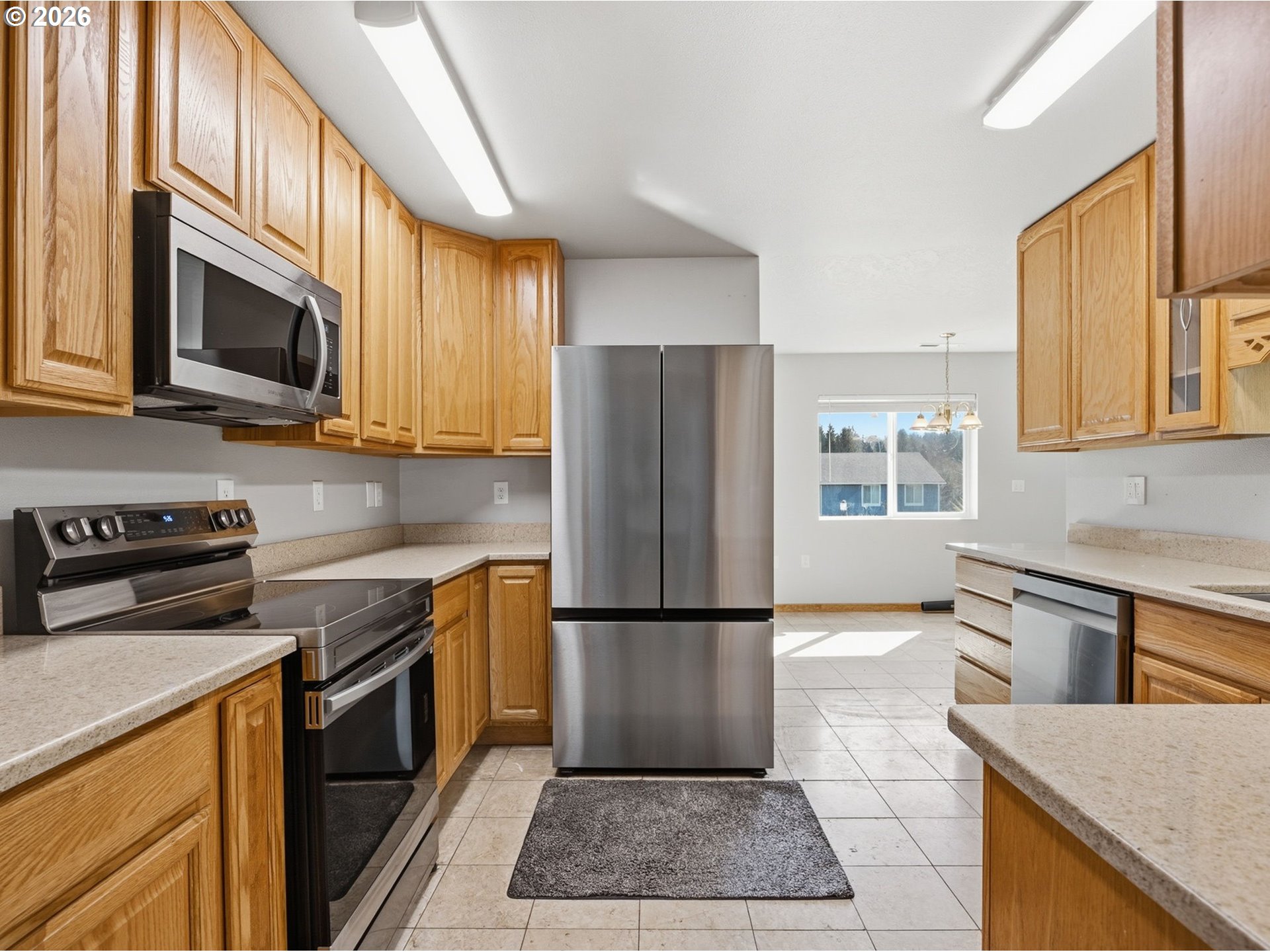 92938 Amie Loop Astoria, OR 97103 - Photo 14 of 42 a kitchen with stainless steel appliances granite countertop a refrigerator stove top oven and sink