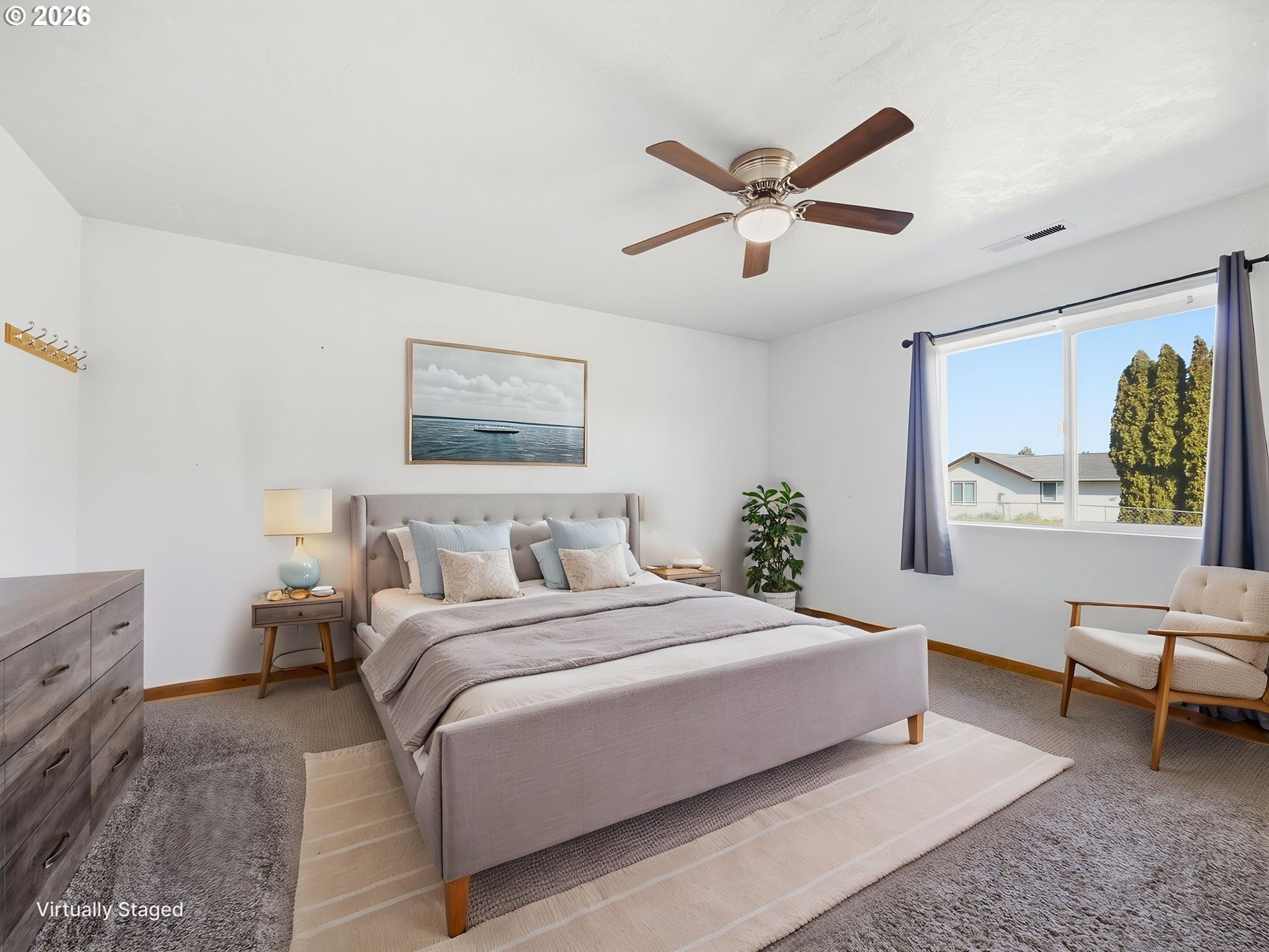 92938 Amie Loop Astoria, OR 97103 - Photo 27 of 42 a bedroom with a bed and a chandelier