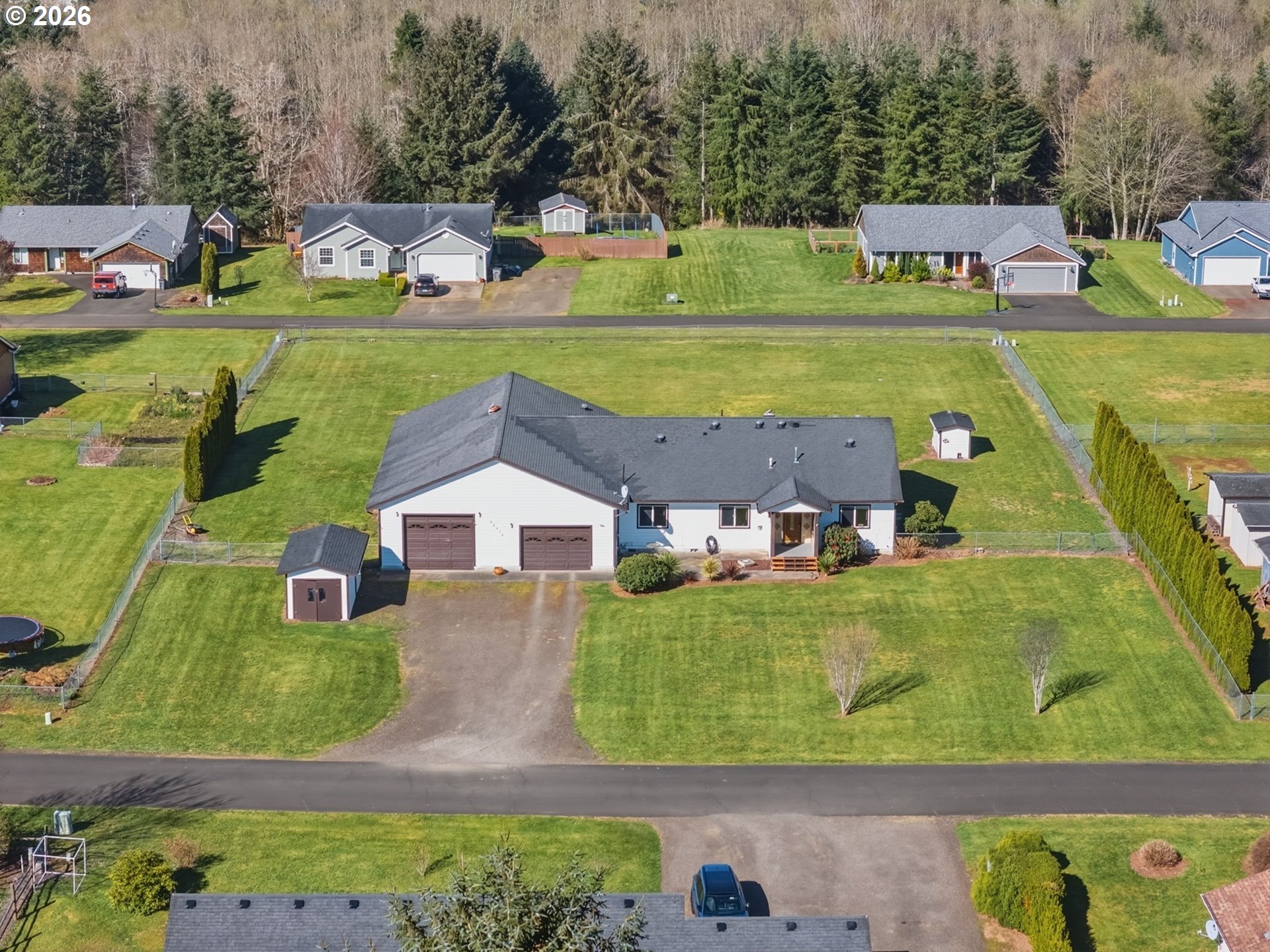 92938 Amie Loop Astoria, OR 97103 - Photo 3 of 42 an aerial view of a house with a garden and lake view
