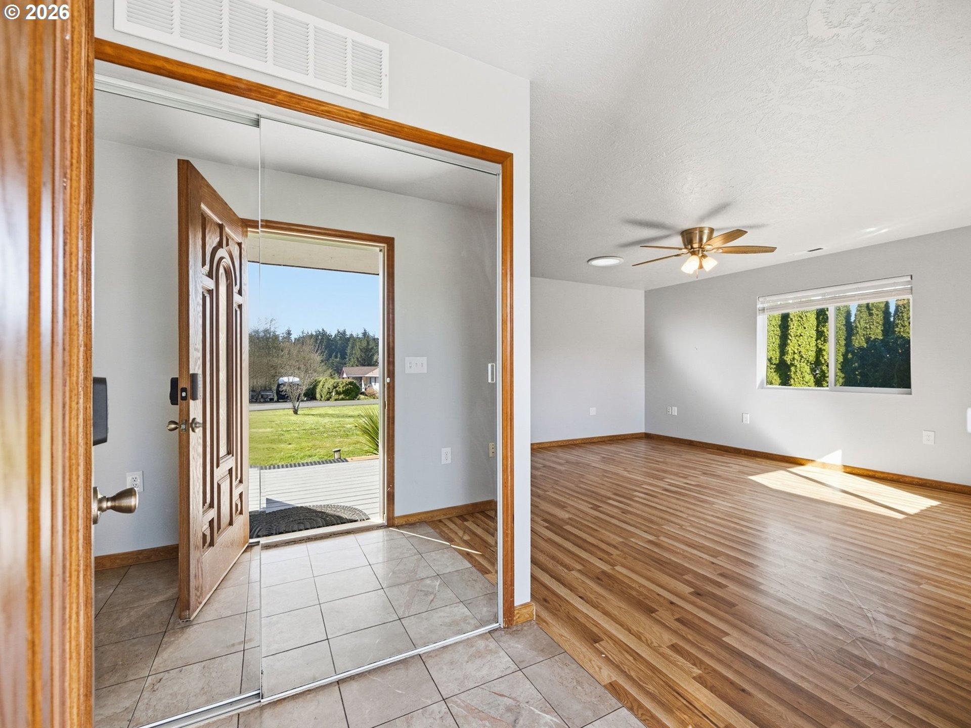 92938 Amie Loop Astoria, OR 97103 - Photo 6 of 42 a view of a hallway with wooden floor and a bathroom