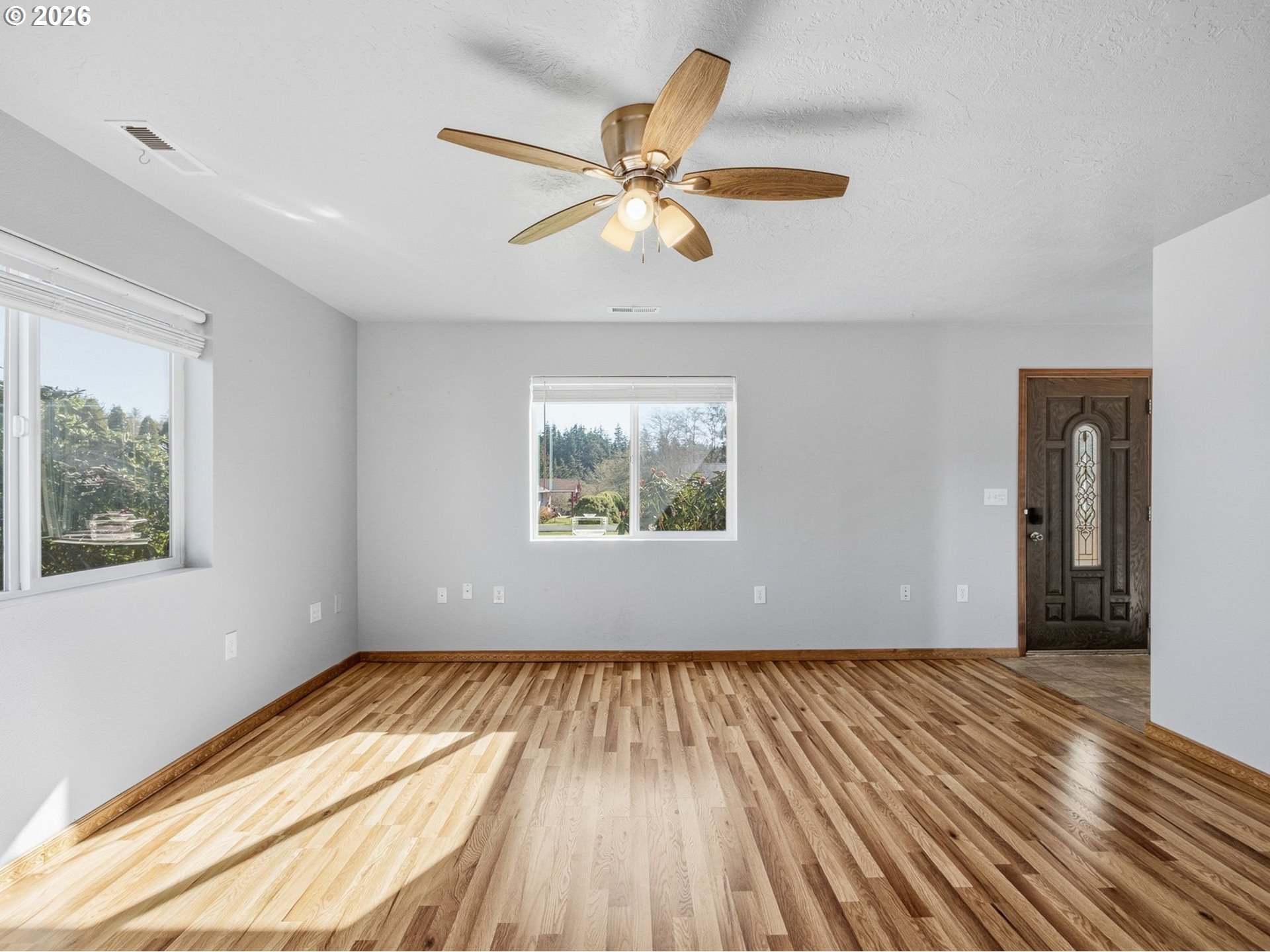 92938 Amie Loop Astoria, OR 97103 - Photo 9 of 42 a view of an empty room with wooden floor and a window