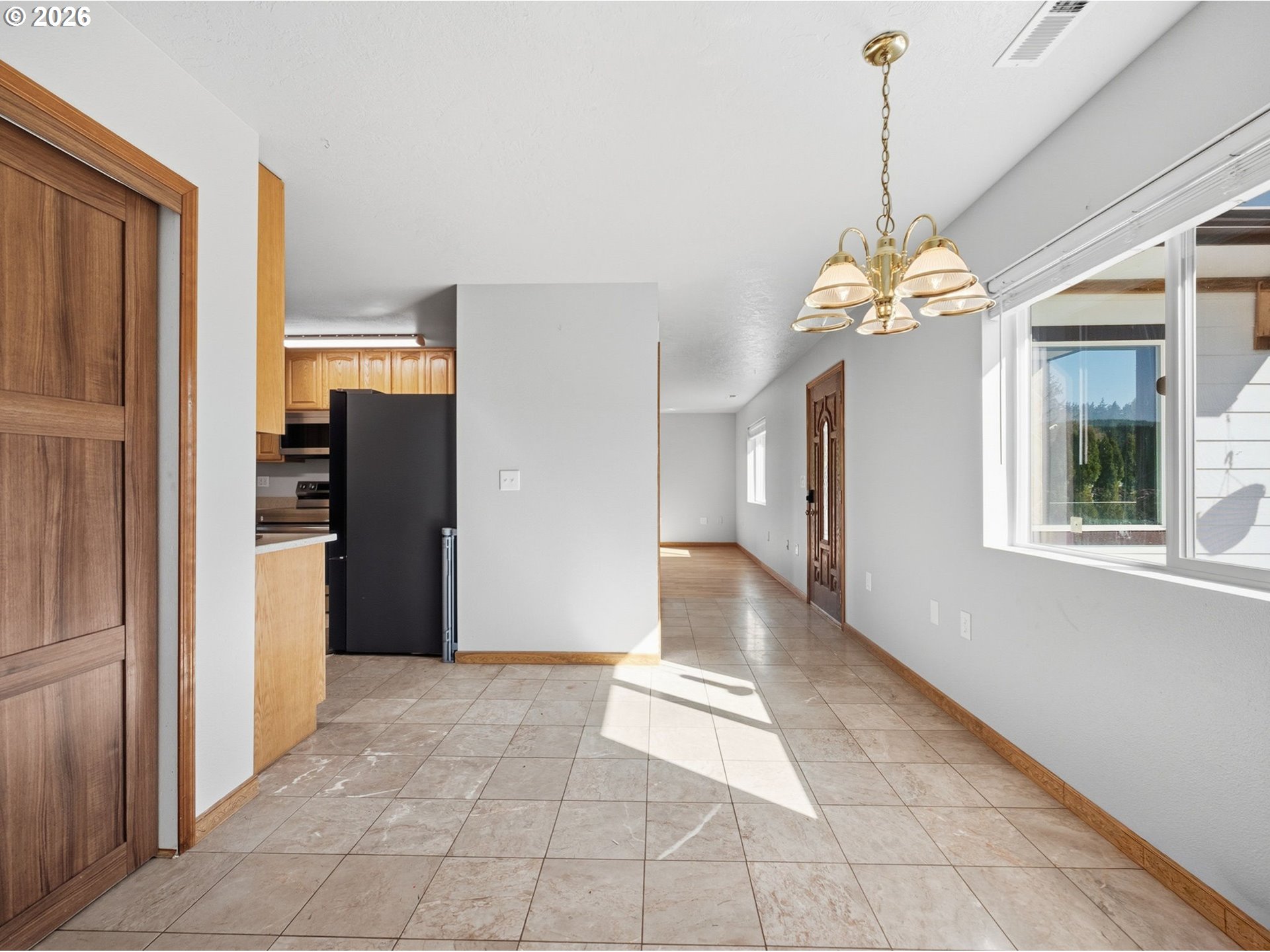 92938 Amie Loop Astoria, OR 97103 - Photo 10 of 42 a view of a hallway with wooden floor and a chandelier