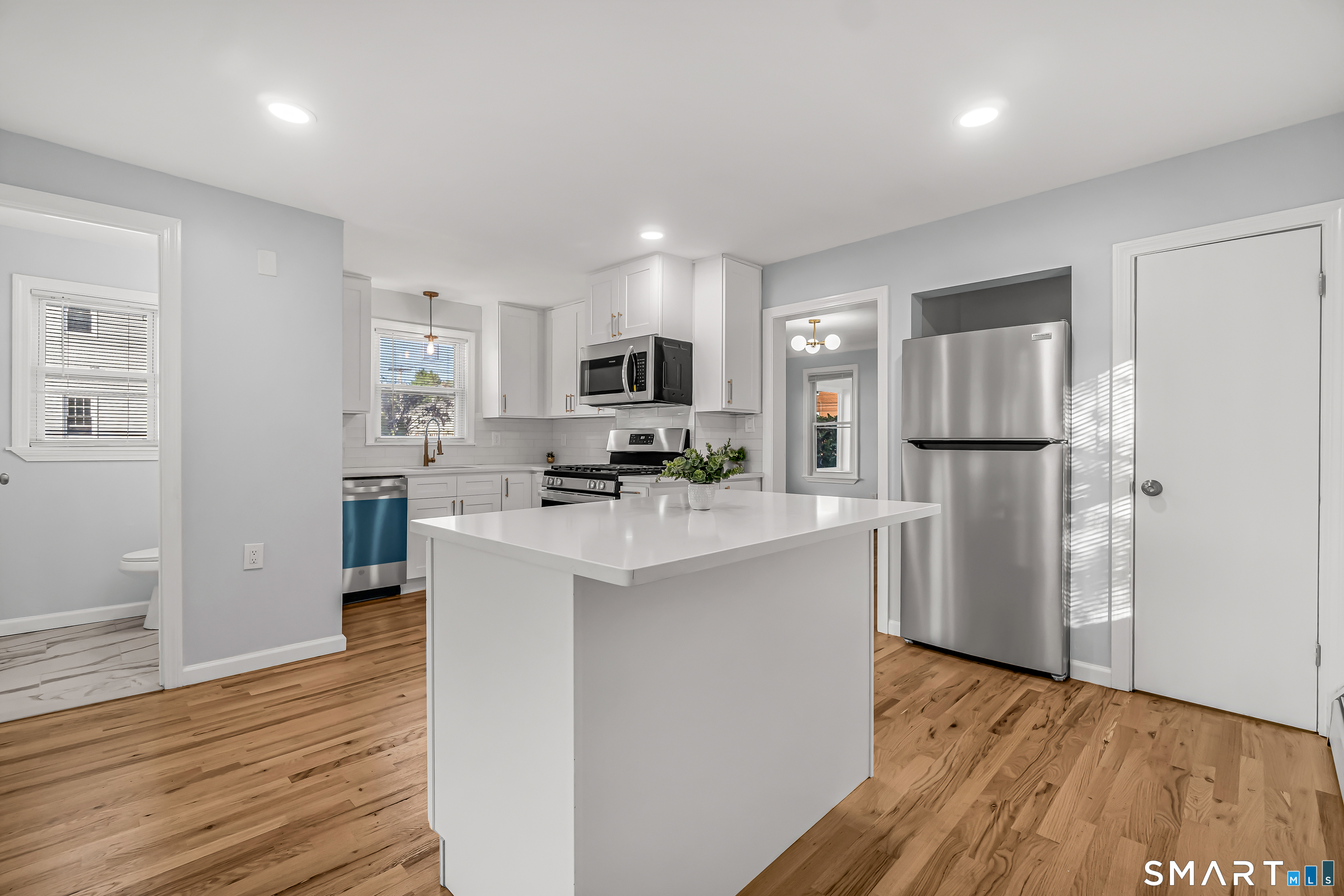 a kitchen with refrigerator and cabinets