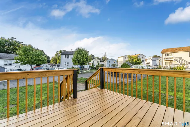 a view of balcony with wooden floor and fence