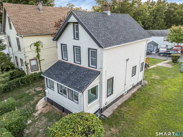 a view of house with backyard and garden