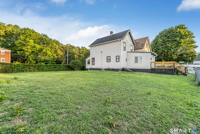 a view of a house with a yard and garage