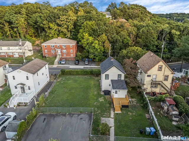 an aerial view of a house with swimming pool garden and patio