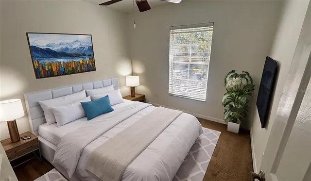 a bedroom with a bed and a painting on the wall