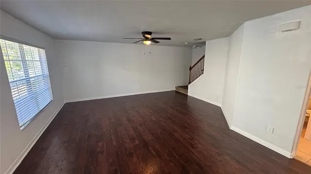 wooden floor in an empty room with a window