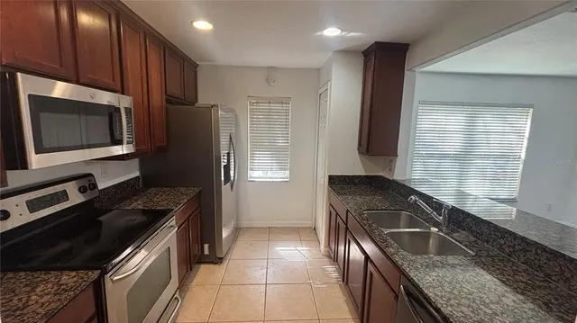 a kitchen that has a sink and a stove