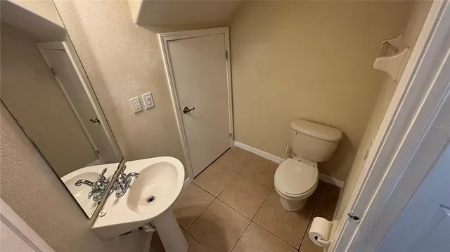 a bathroom with a toilet and a mirror