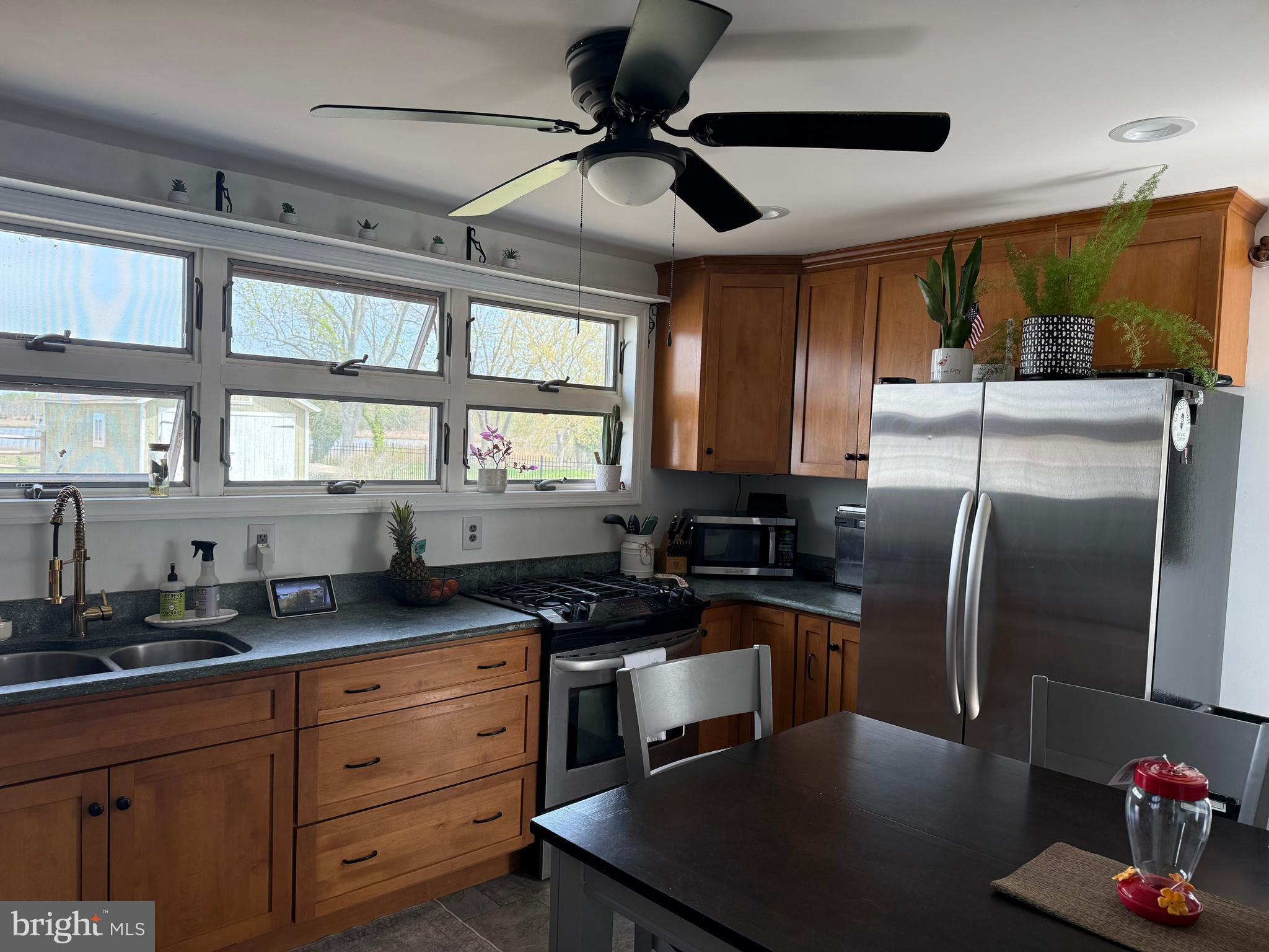 303 Baptist Road Newport, NJ 08345 - Photo 11 of 37 a kitchen with granite countertop a sink stainless steel appliances and cabinets