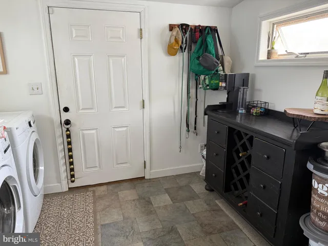 a view of a kitchen with a sink and a washer dryer