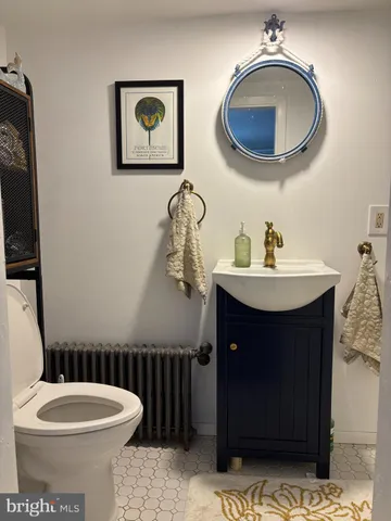 a bathroom with a toilet a sink and a mirror