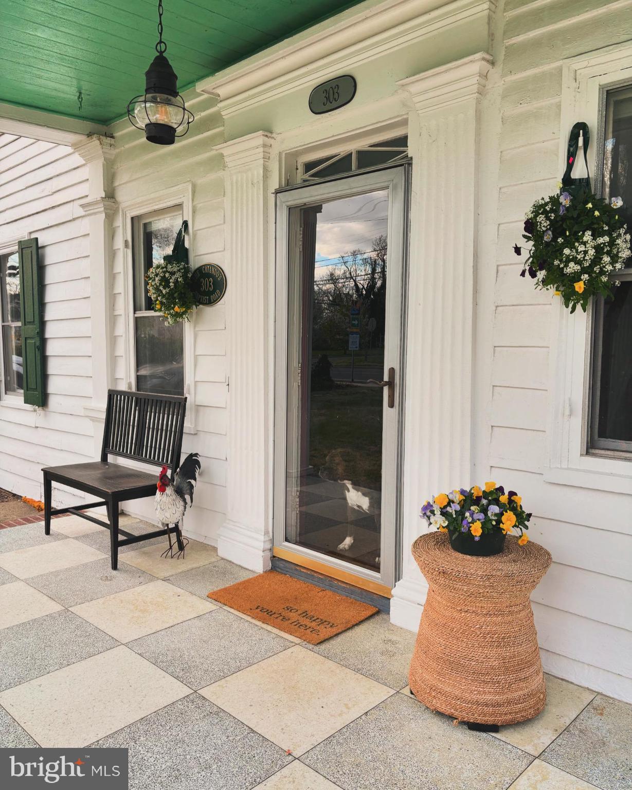 303 Baptist Road Newport, NJ 08345 - Photo 2 of 37 a front view of a house with a potted plant