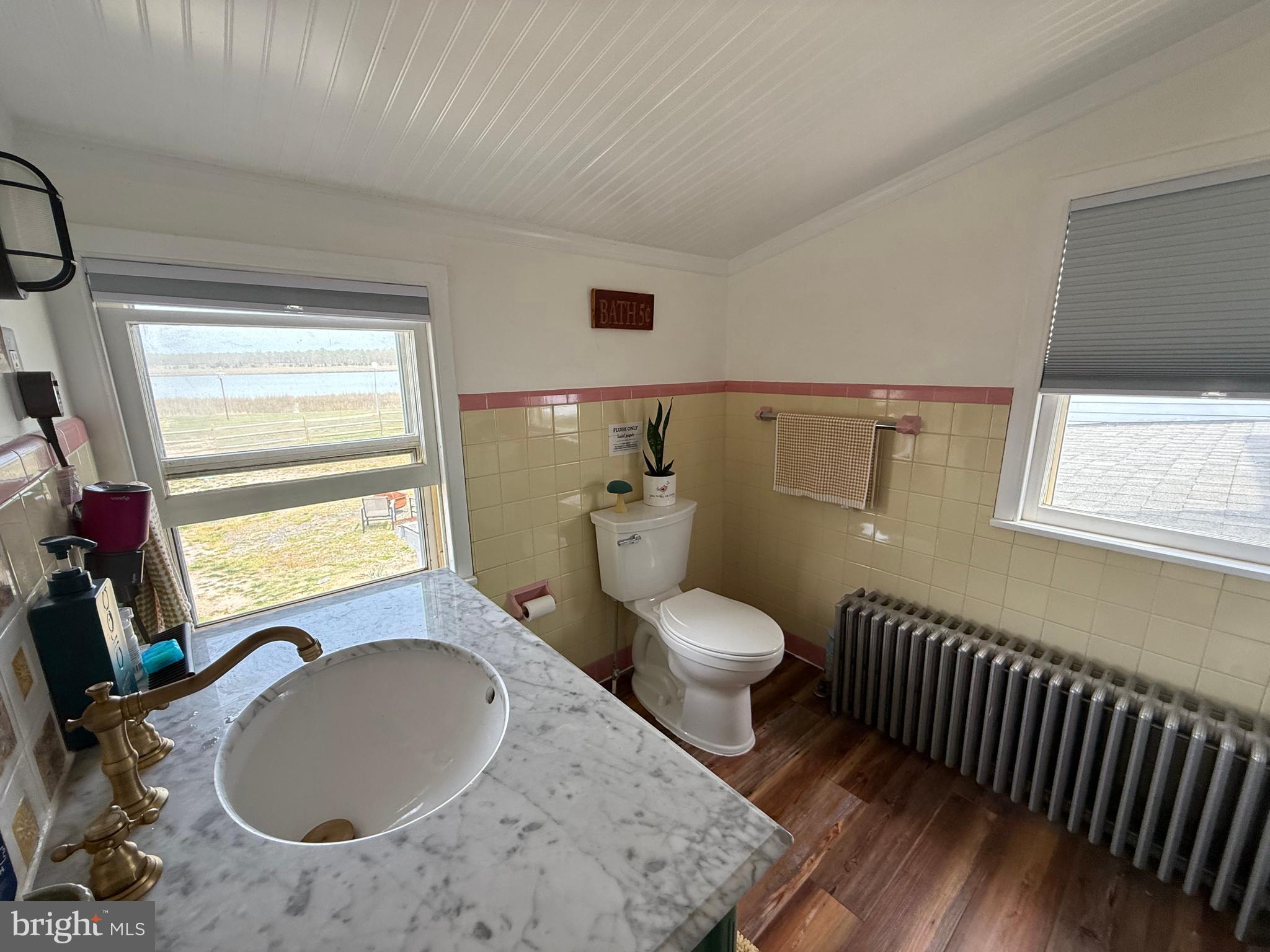 303 Baptist Road Newport, NJ 08345 - Photo 23 of 37 a bathroom with a sink toilet vanity and window